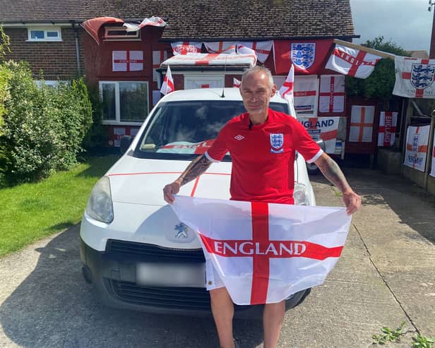 Martin Baker pictured outside his St George's flag covered home. 